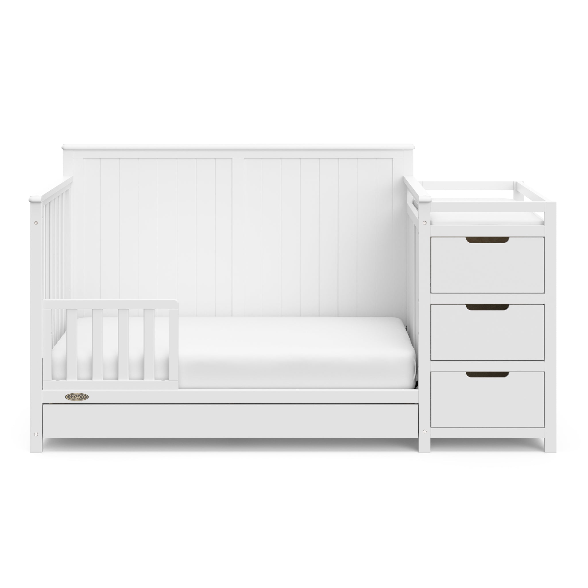 White crib and changer with drawer in toddler bed conversion with one safety guardrail 