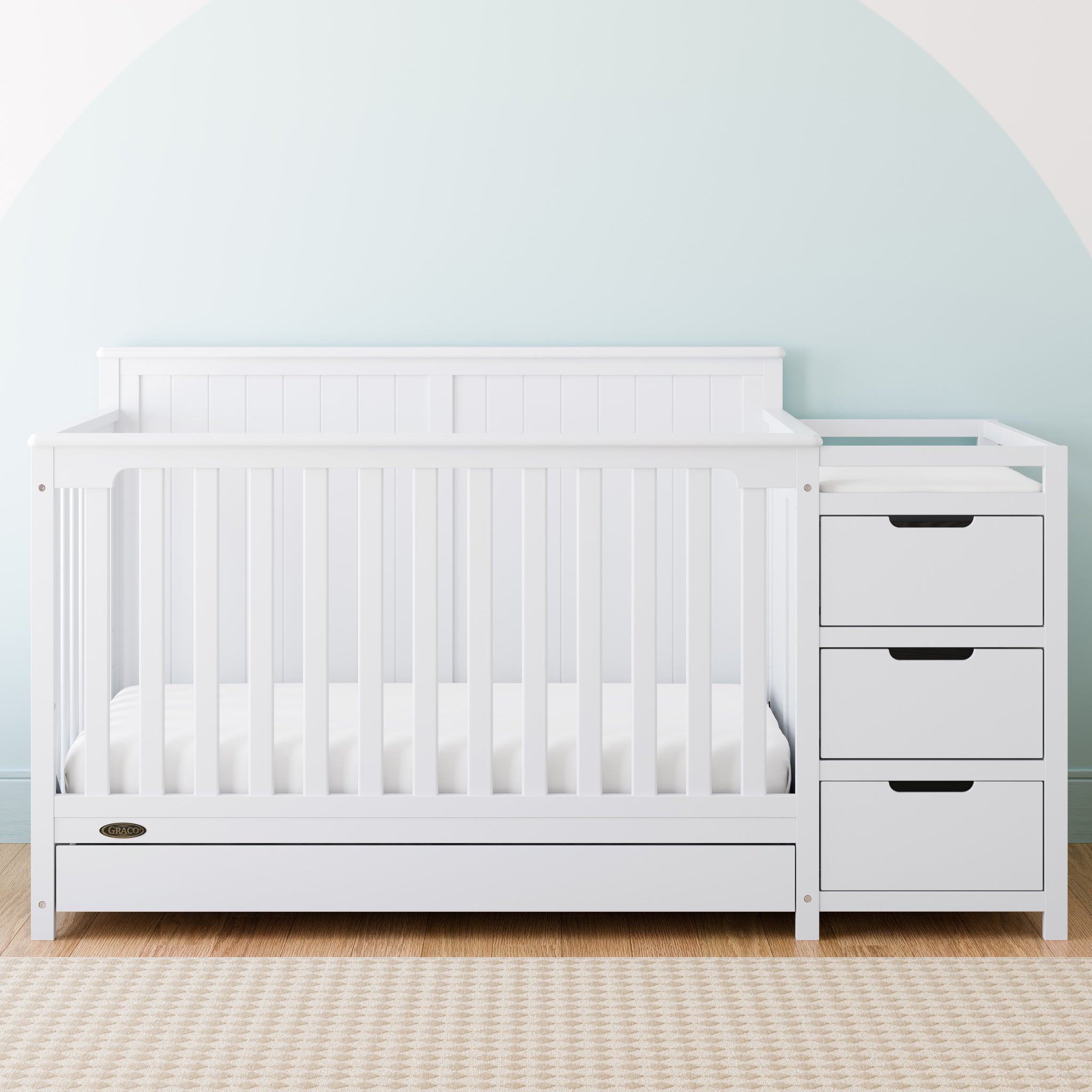 White crib and changer with drawer in nursery