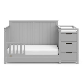 Pebble gray crib and changer with drawer in toddler bed conversion with one safety guardrail 