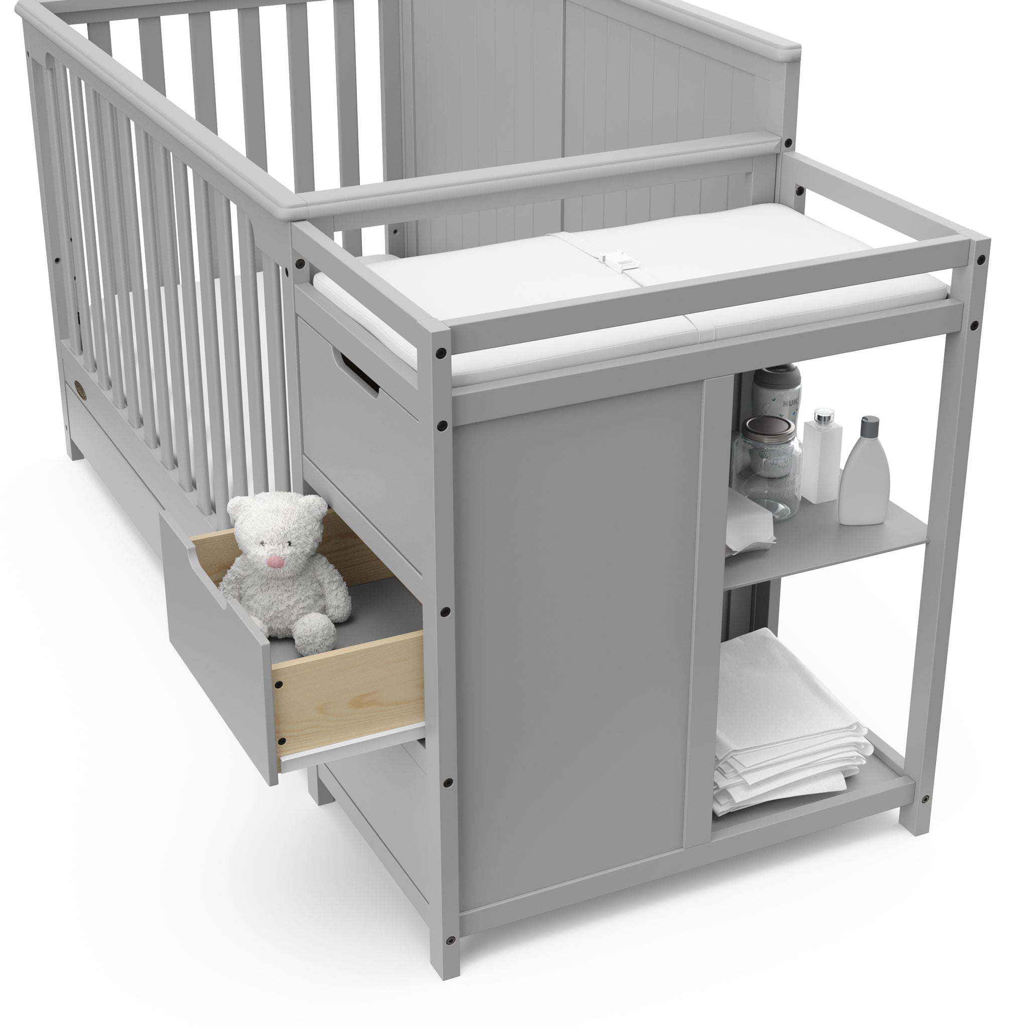 Close-up view of Pebble gray crib and changer with open drawer