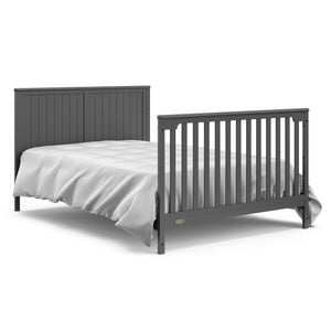 gray crib and changer with drawer in full-size bed with headboard and footboard conversion