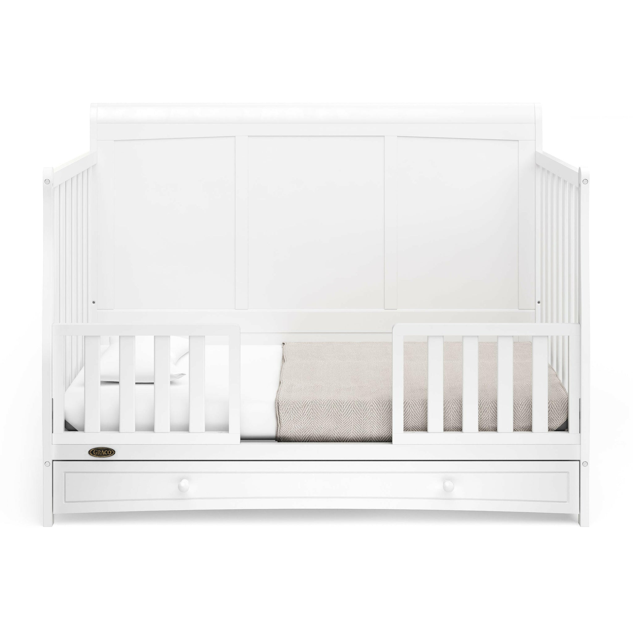 White crib with drawer in toddler bed conversion with two safety guardrails