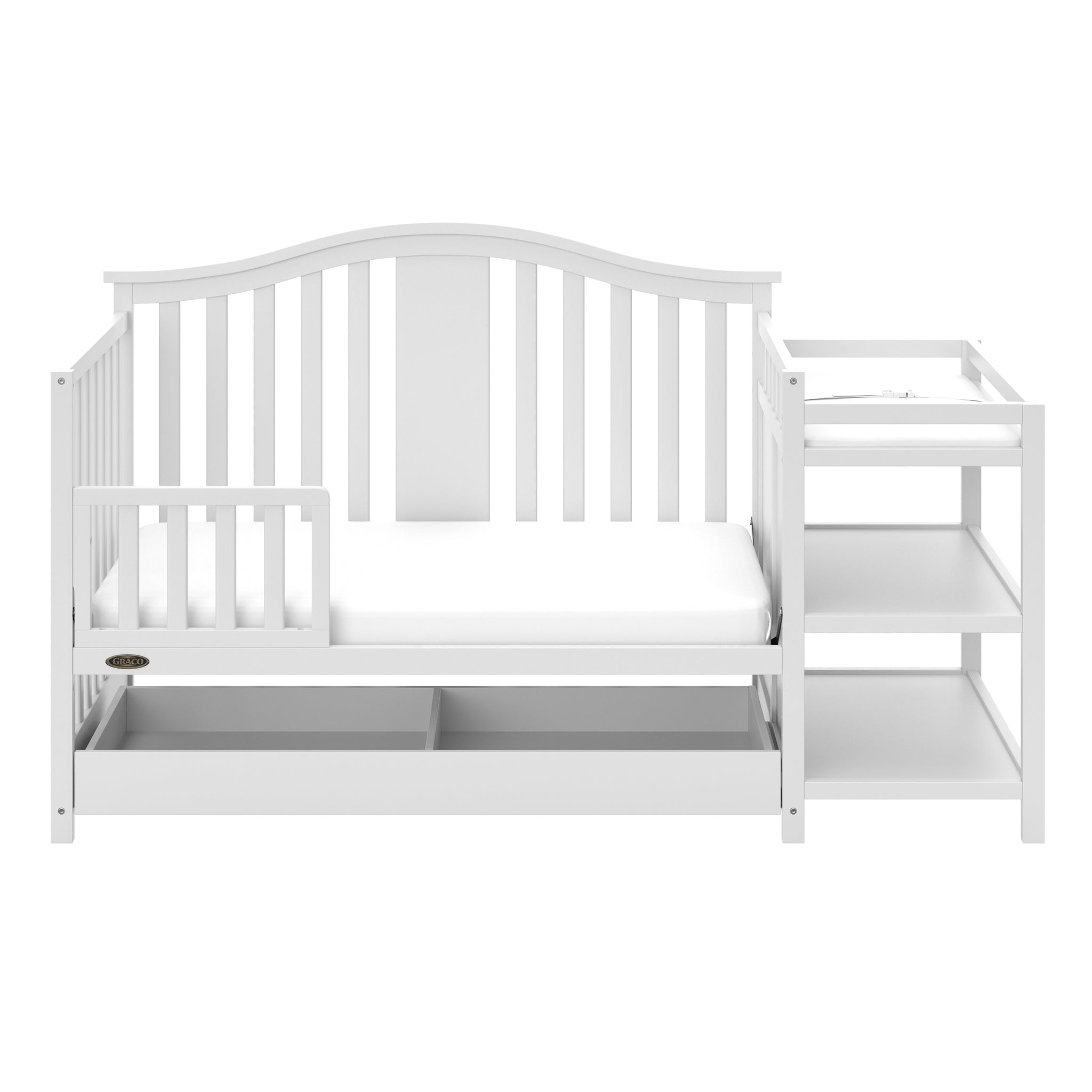 White crib in toddler bed conversion with one safety guardrail