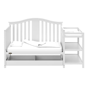White crib and changer in daybed conversion with open drawer