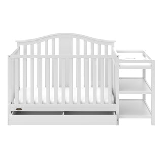 Front view of White crib and changer with open drawer