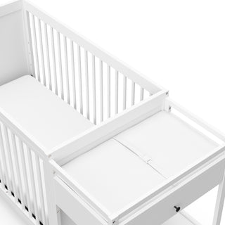 Close-up view of White crib and changer