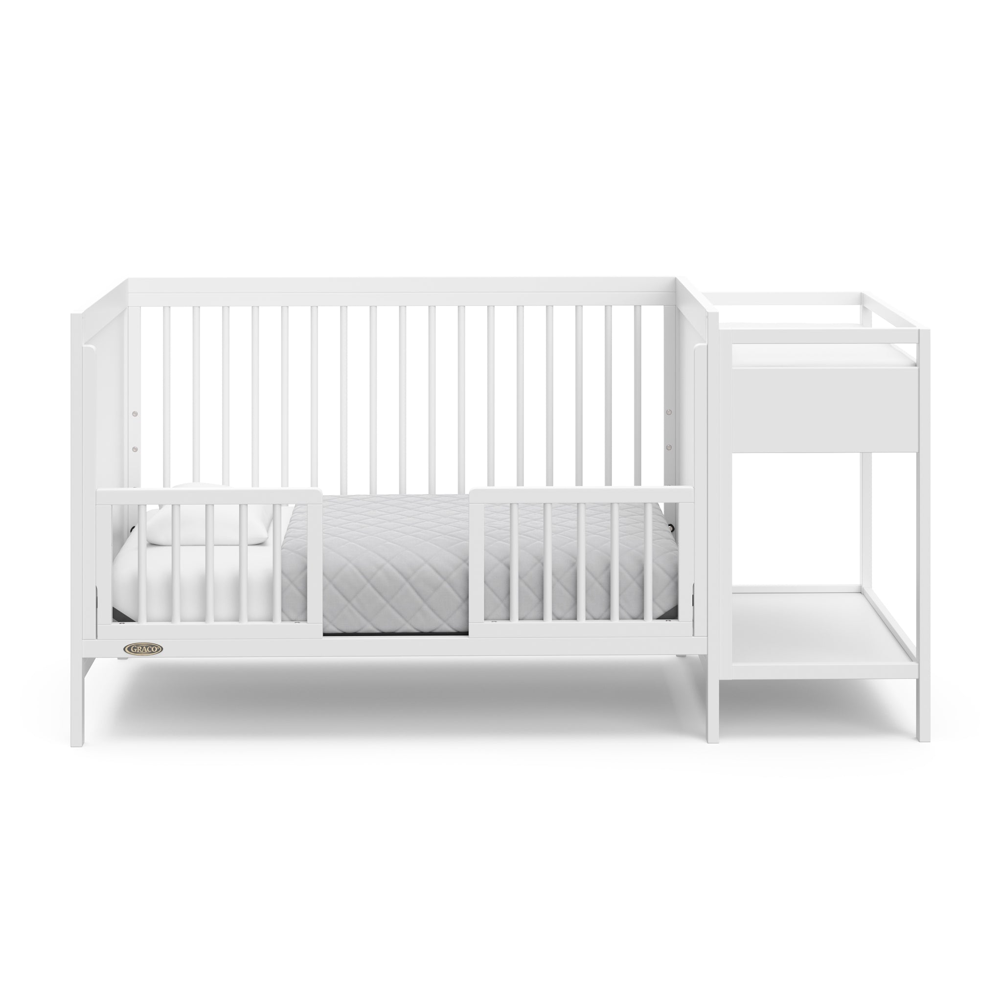 White crib in toddler bed conversion with two safety guardrails