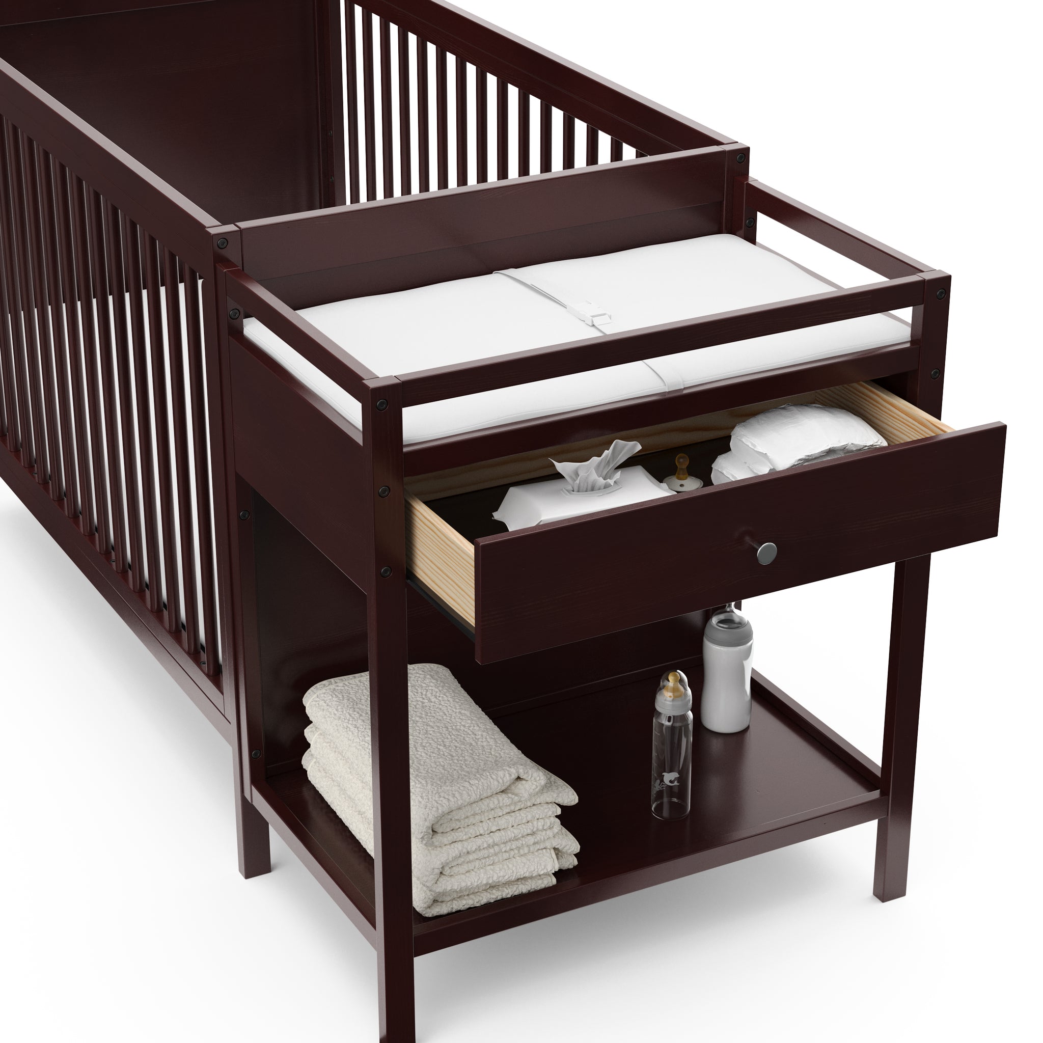 Close-up view of espresso crib and changer with open drawer