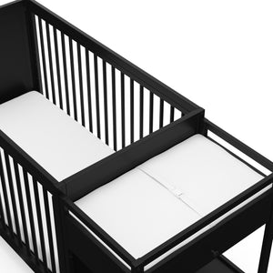 Close-up view of black crib and changer