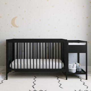 black crib and changer in nursery