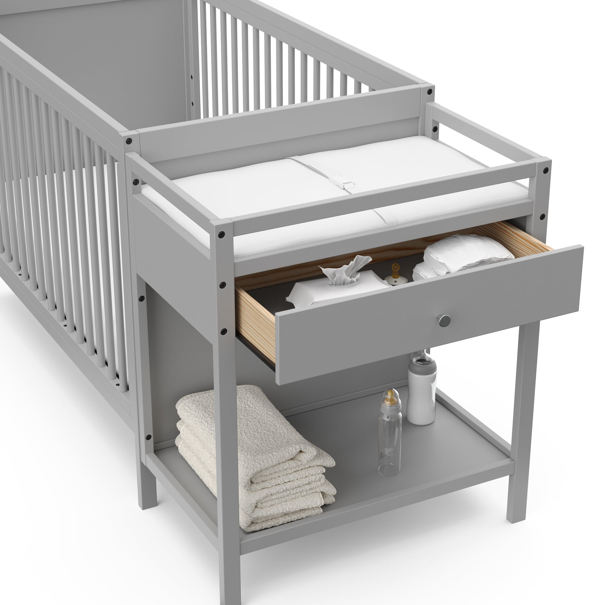 Close-up view of Pebble gray crib and changer with open drawer