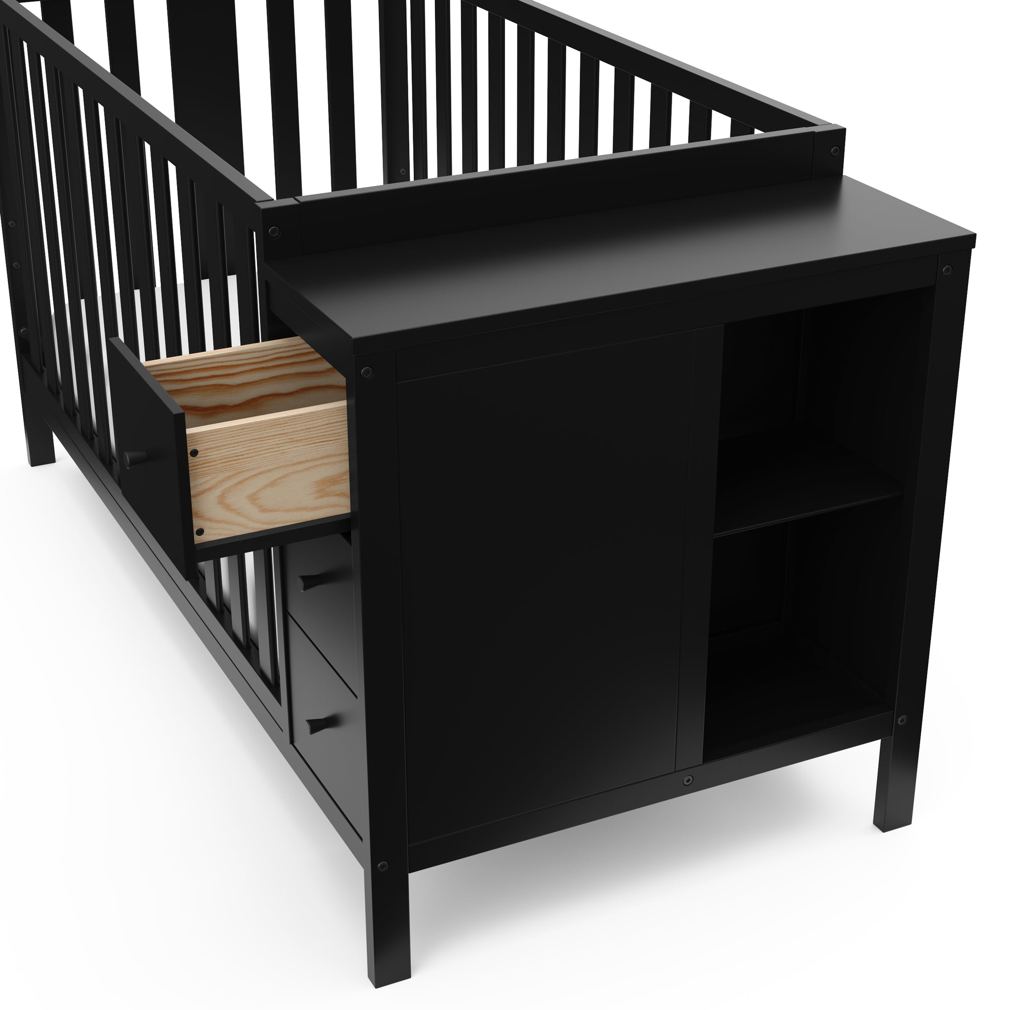 Close-up view of black crib with storage and open drawer