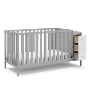 pebble gray and white crib with storage and open drawers angled