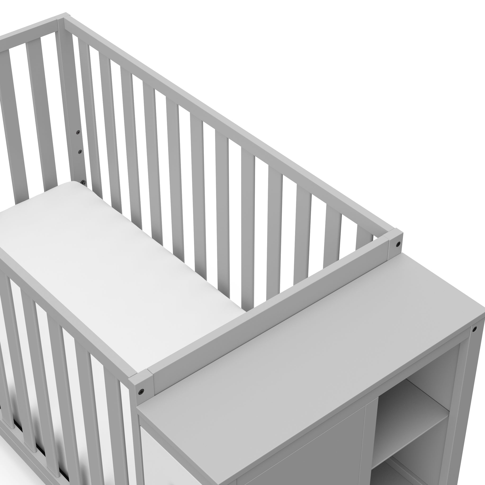 Close-up view of pebble gray and white crib with storage headboard