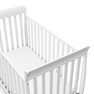 Close-up view of white crib's headboard