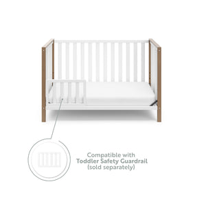 White crib with driftwood in toddler bed conversion with one safety guardrail graphic