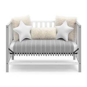 White crib with pebble gray in day bed conversion