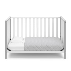 White crib with pebble gray in toddler bed conversion