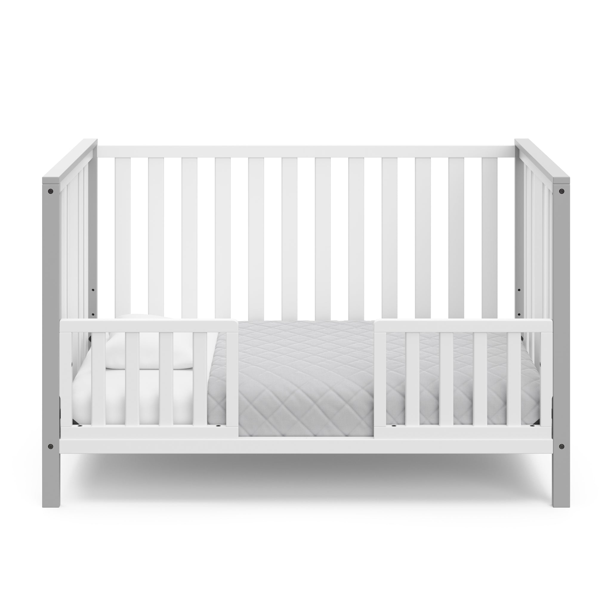 White crib with pebble gray in toddler bed conversion with two safety guardrails