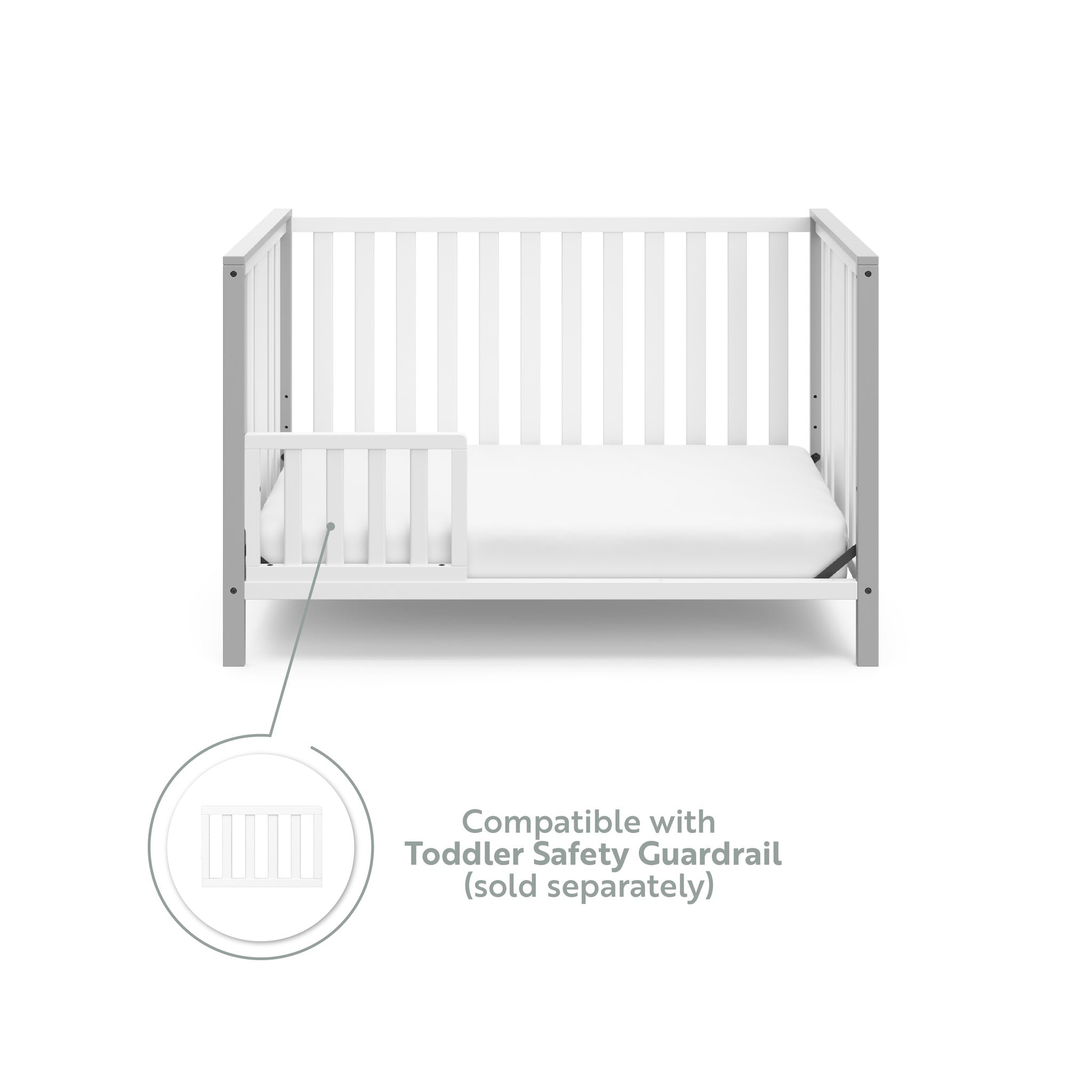White crib with pebble gray in toddler bed conversion with one safety guardrail graphic