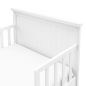 Close-up view of white toddler bed’s headboard