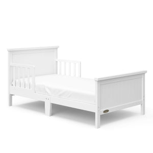 White toddler bed with guardrails angled