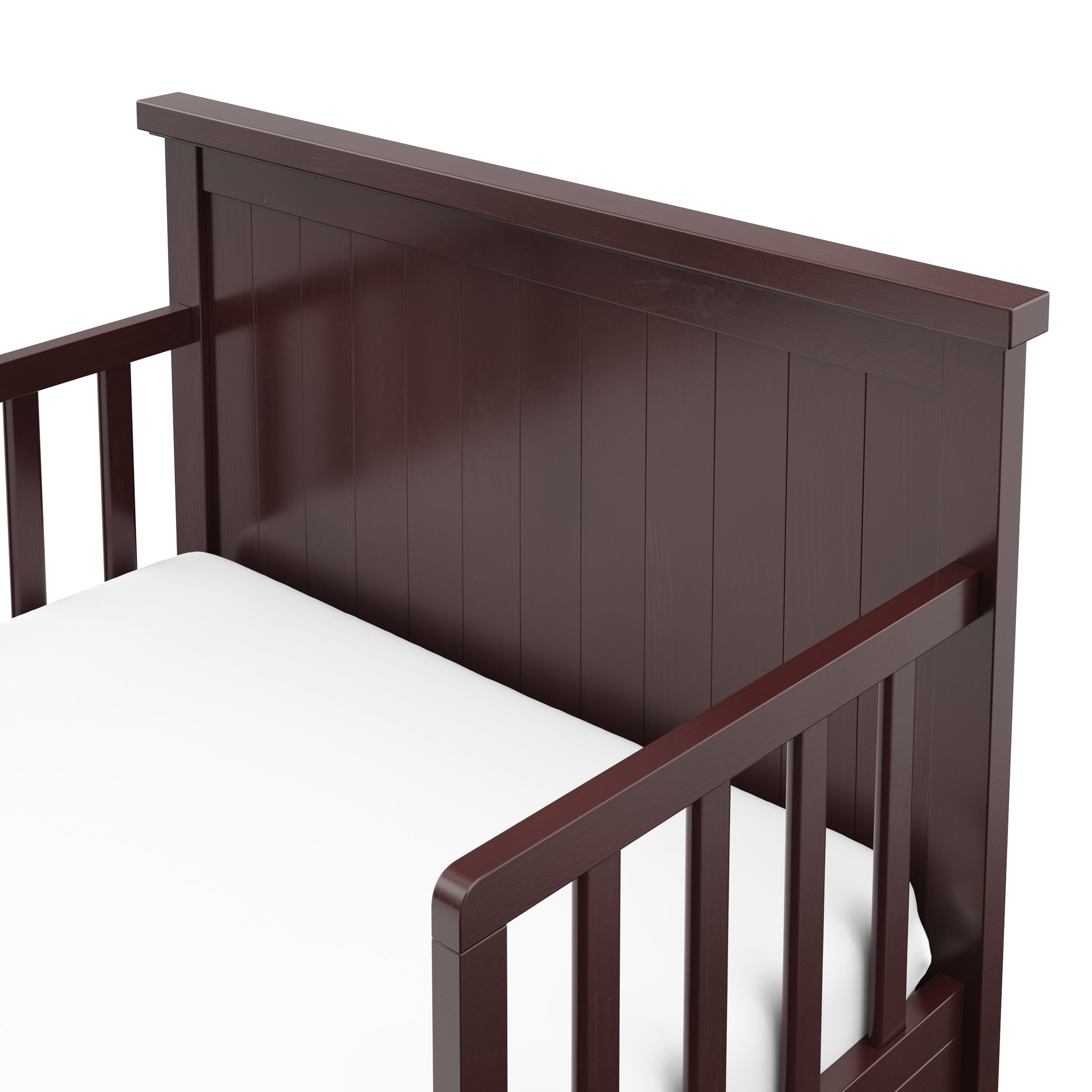 Close-up view of espresso toddler bed’s headboard