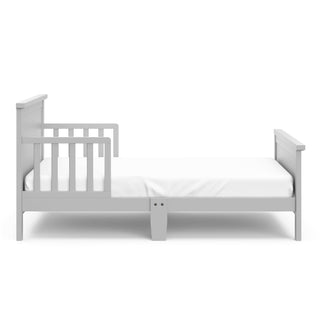 Side view of pebble gray toddler bed with guardrails