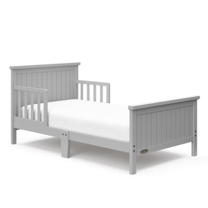 Pebble gray toddler bed with guardrails angled