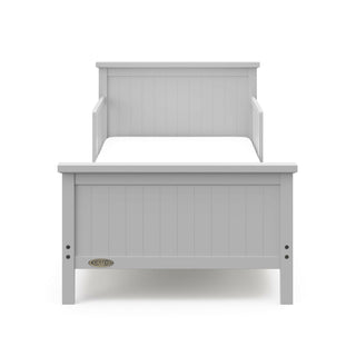 Front view of pebble gray toddler bed with guardrails