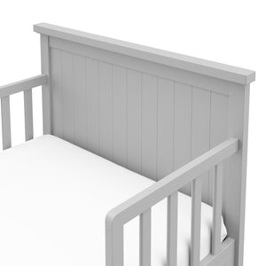 Close-up view of pebble gray toddler bed’s headboard