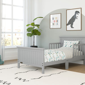 pebble gray toddler bed with guardrails in nursery