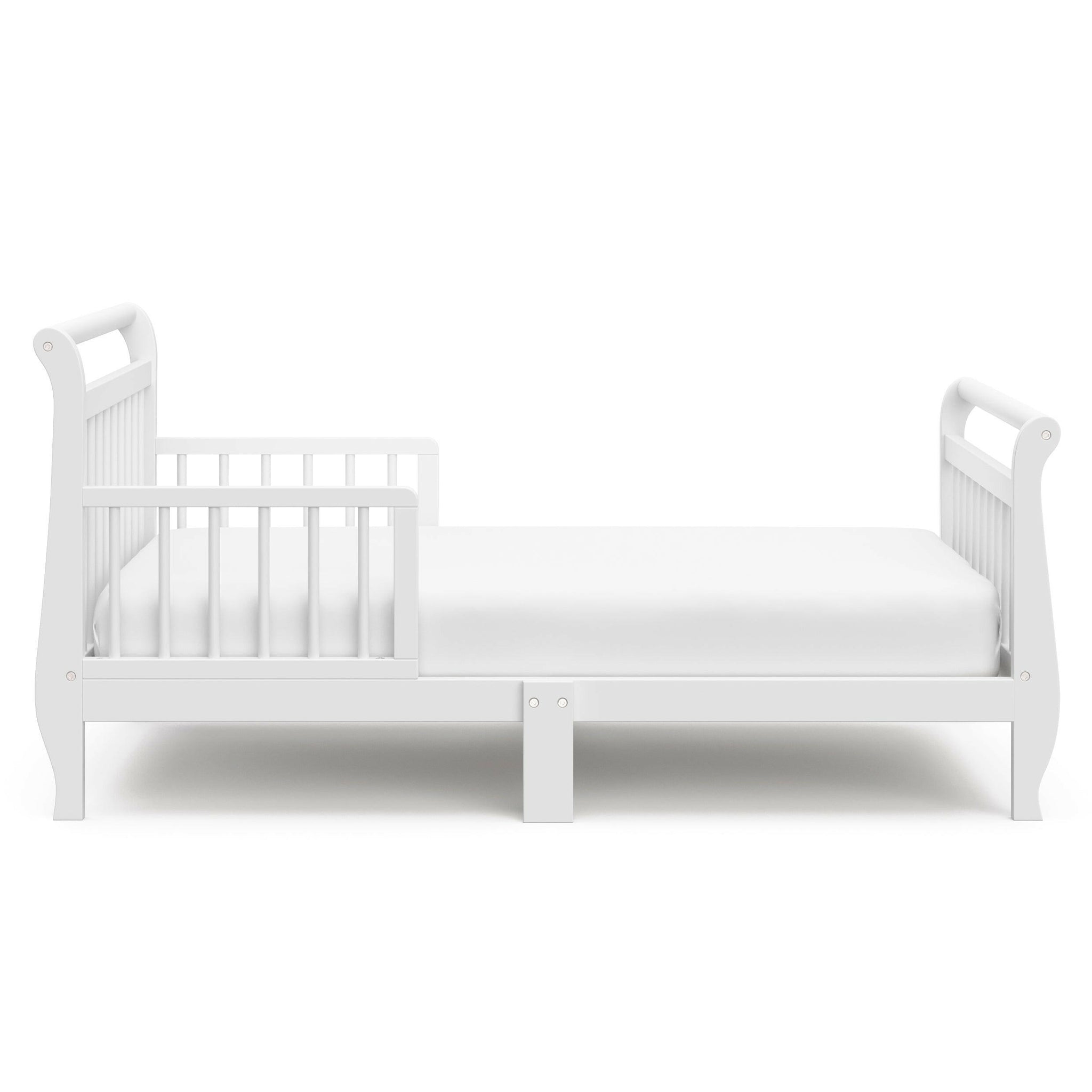 Side view of white toddler bed with guardrails