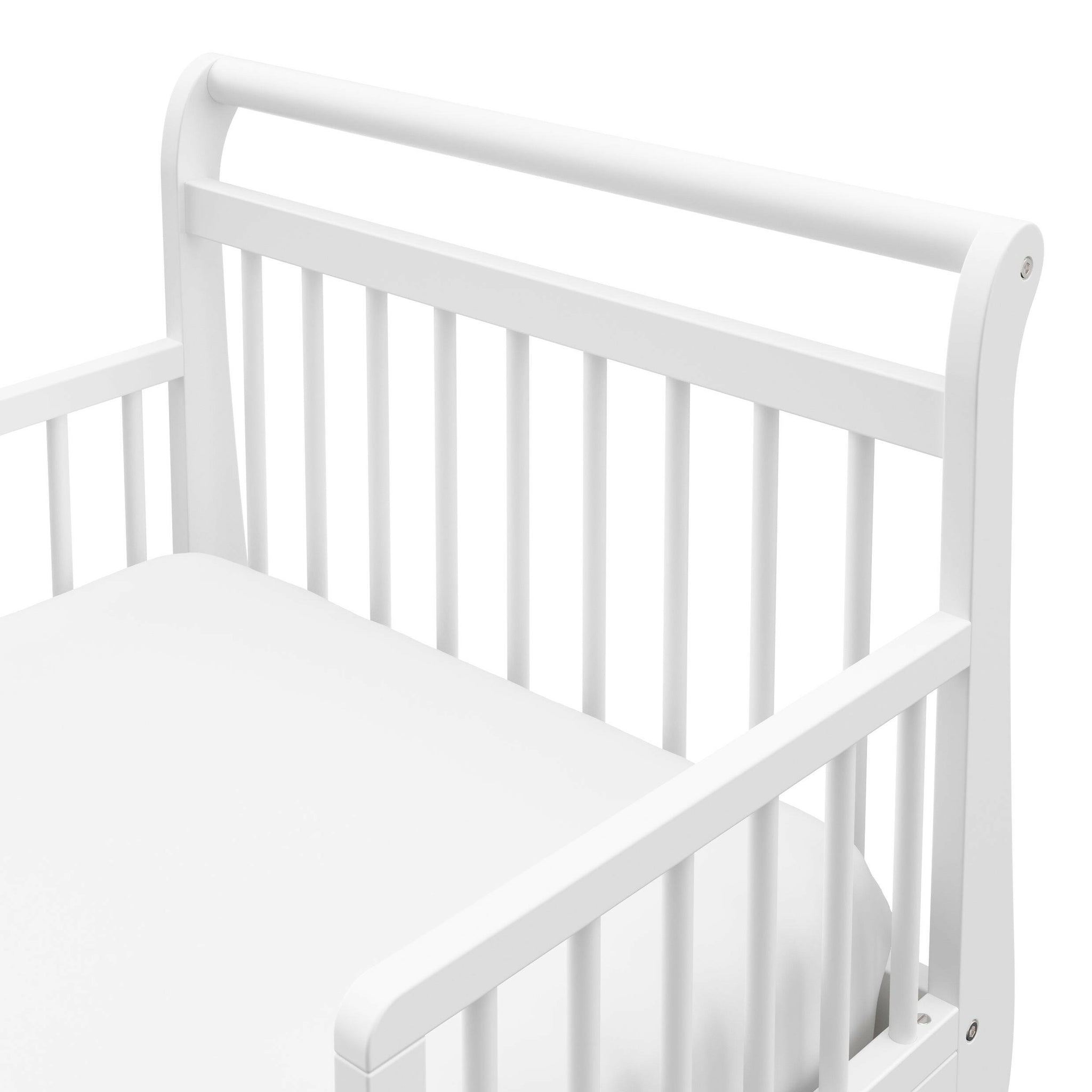 Close-up view of white toddler bed’s headboard