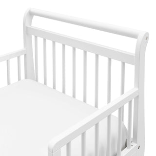 Close-up view of white toddler bed’s headboard