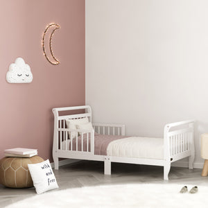 white toddler bed with guardrails in nursery