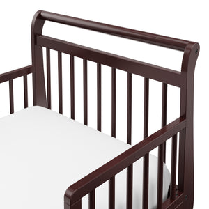 Close-up view of espresso toddler bed’s headboard