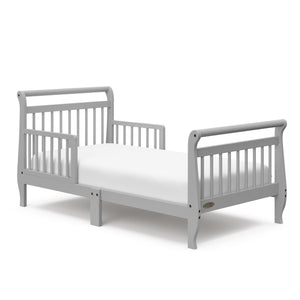 Pebble gray toddler bed with guardrails angled
