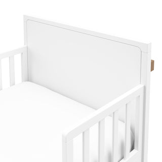 Close-up view of white toddler bed’s headboard