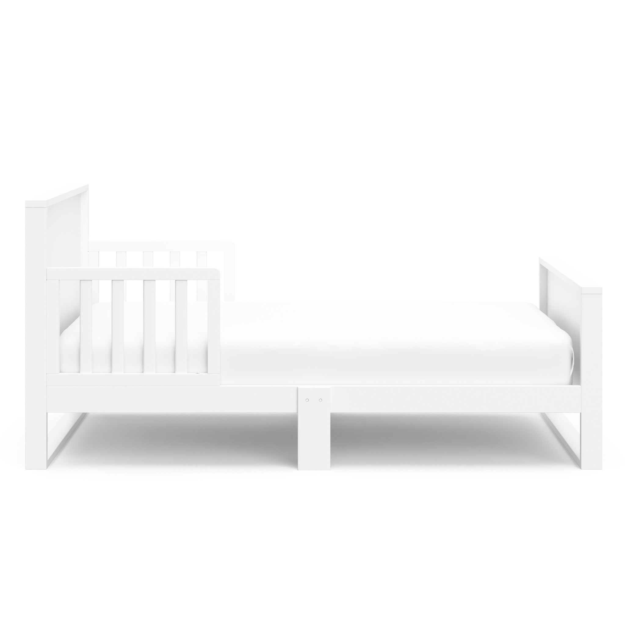 Side view of white toddler bed with guardrails 