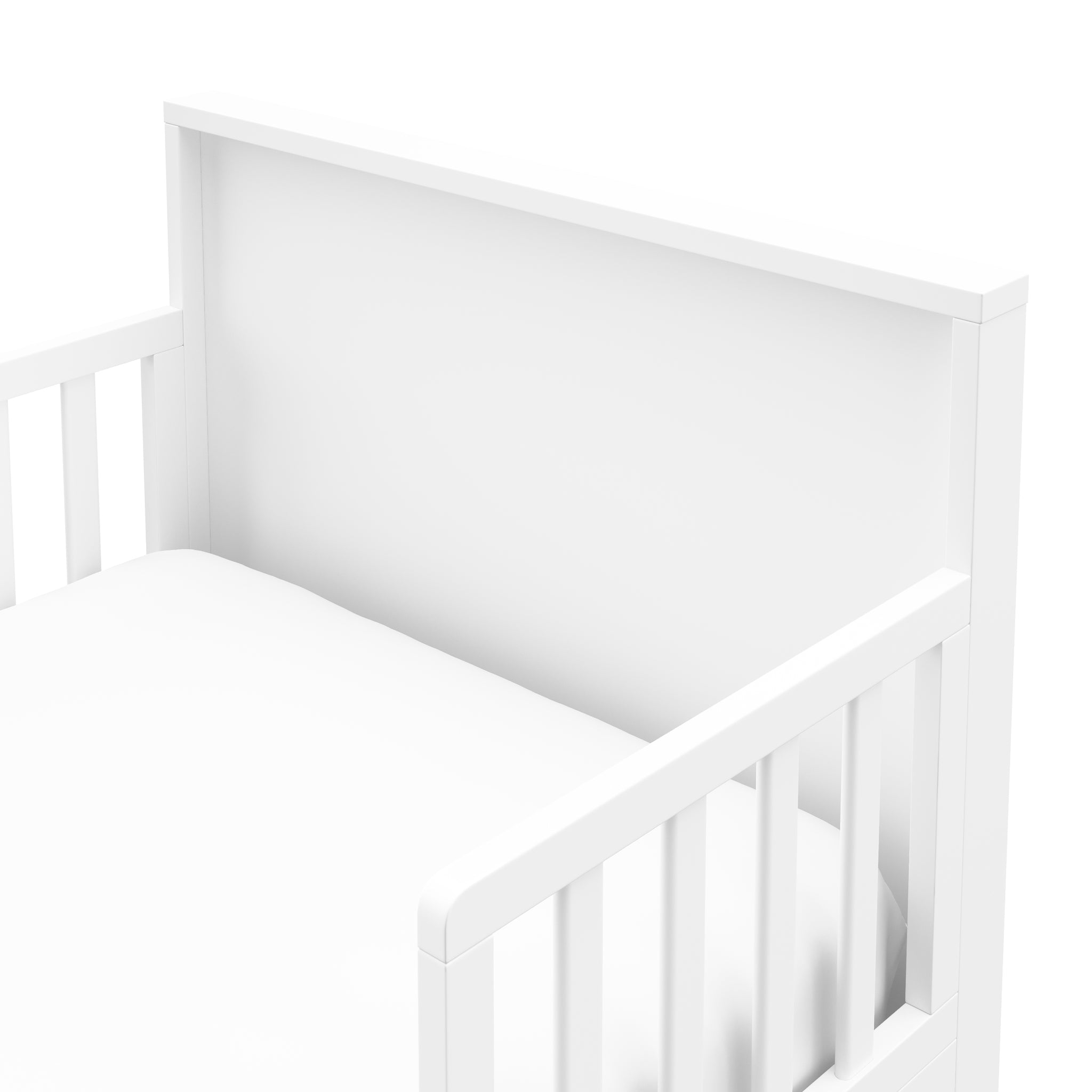 Close-up view of white toddler bed’s headboard 