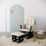 black glider and ottoman with beige cushions in nursery