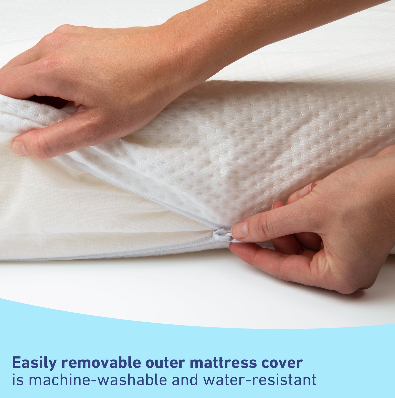 hands removing baby mattress outer cover