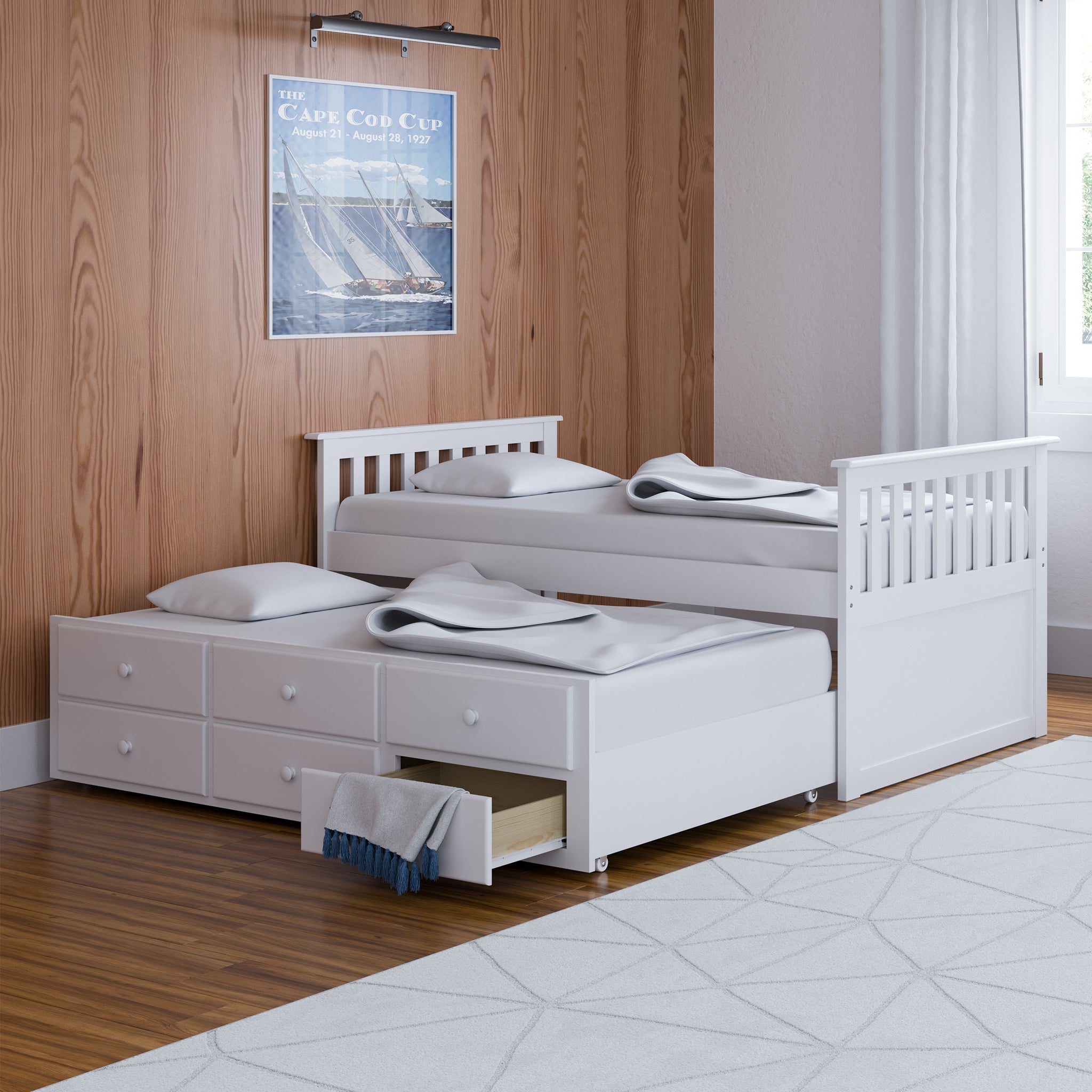 White twin size captains bed with open twin trundle and open drawer in nursery
