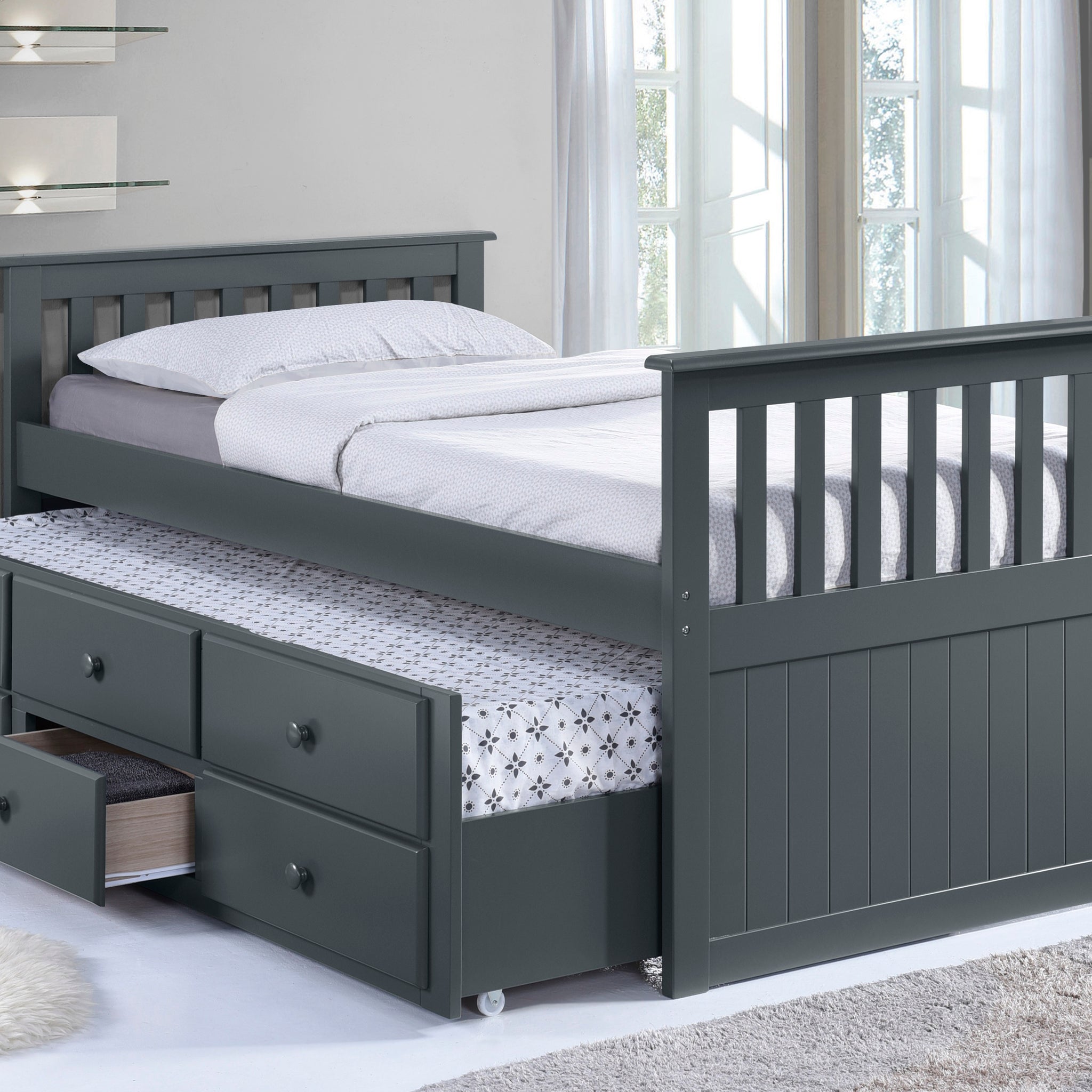 gray twin size captains bed with open twin trundle and open drawer in nursery angled