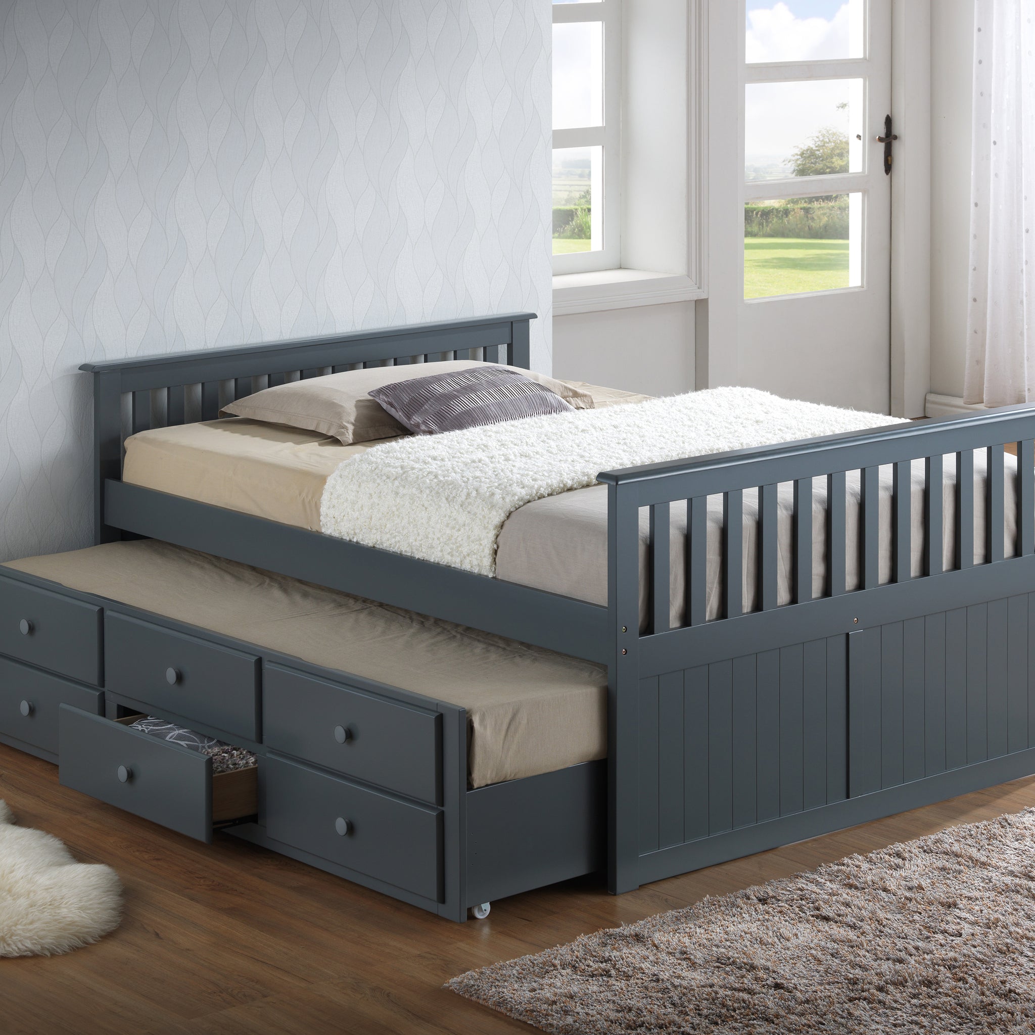 gray full size captains bed with open twin trundle and open drawer in nursery