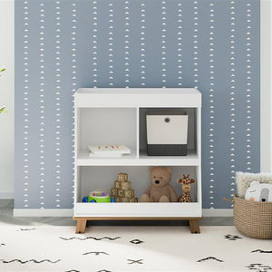 Front view of white with driftwood changing table with storage in nursery