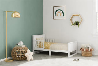 White toddler bed in nursery 