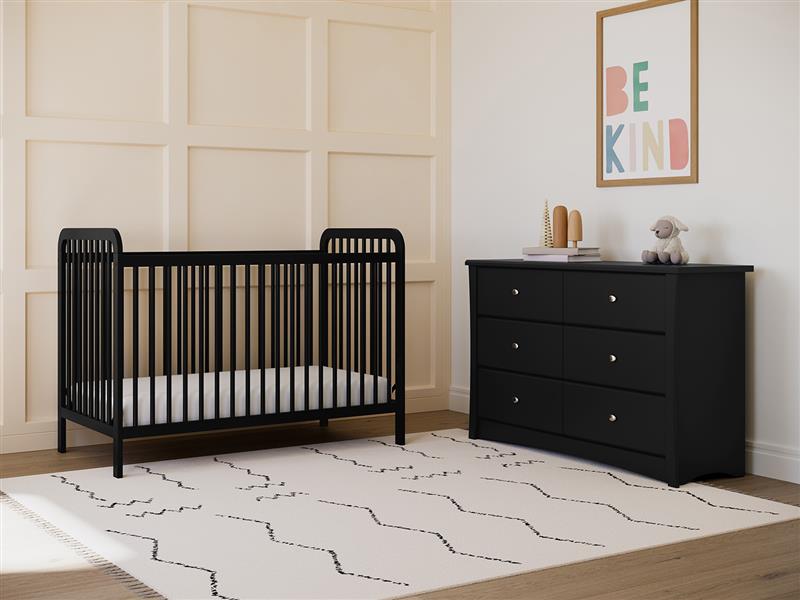 black crib in nursery with 6 drawer chest