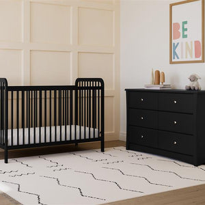 black crib in nursery with 6 drawer chest